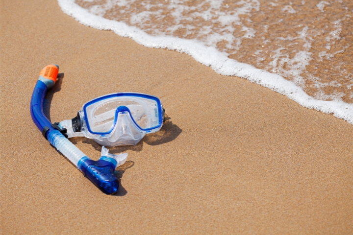 Mask and snorkel lay on Los Cabos beach