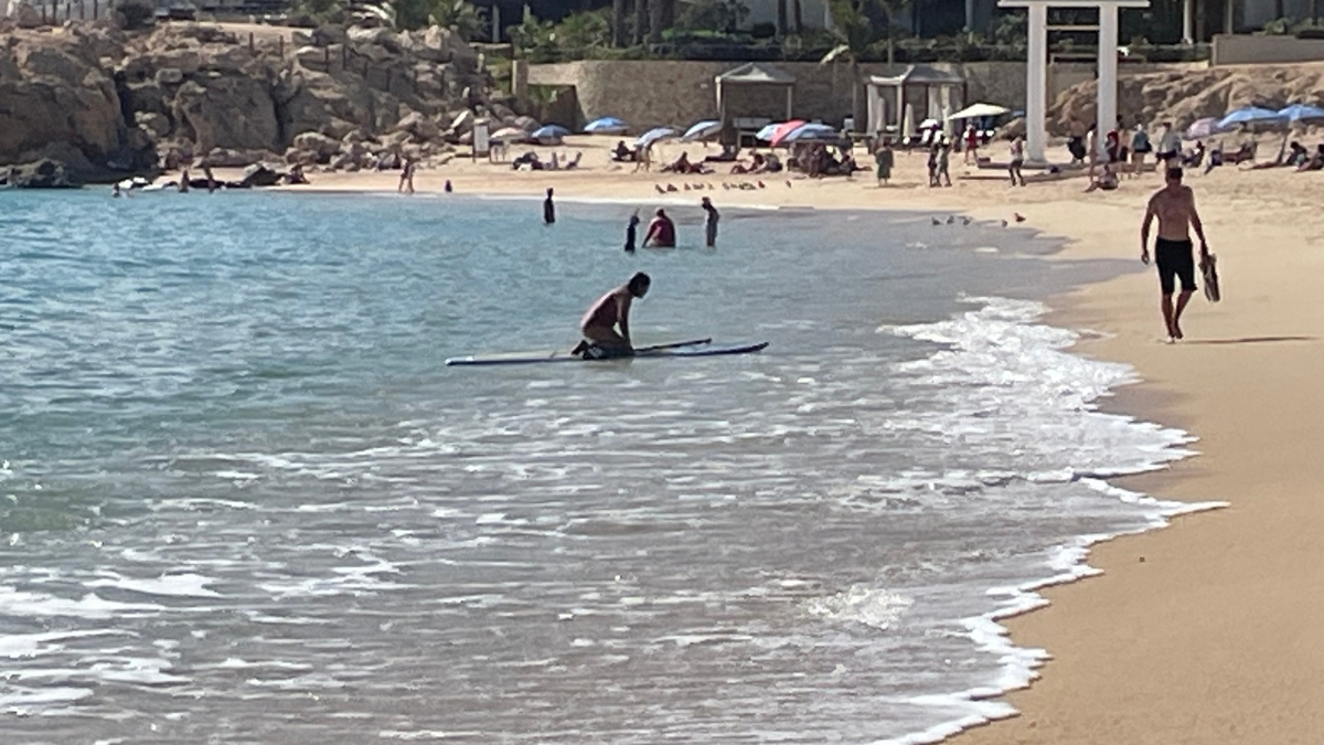 Paddleboarder aand snorkeler are common things to do in Chileno Beach