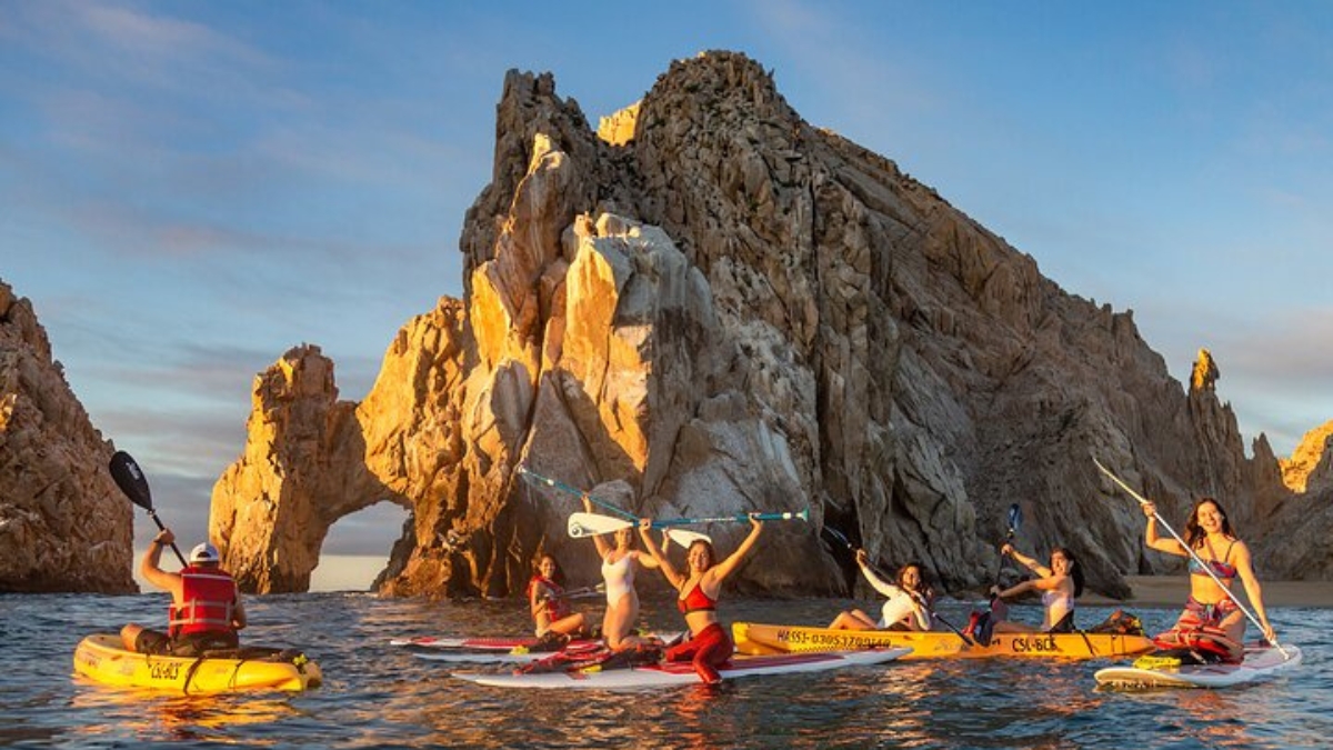 Group of kayakers with Cabo's Arch in the background